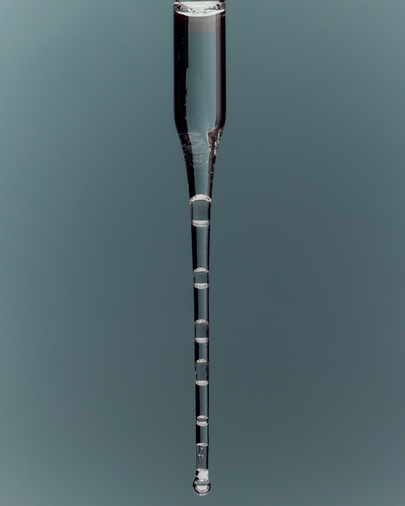 dieux Dieux-clear-glass-dropper-releasing-a-stream-of-liquid-with-distinct-bubbles.