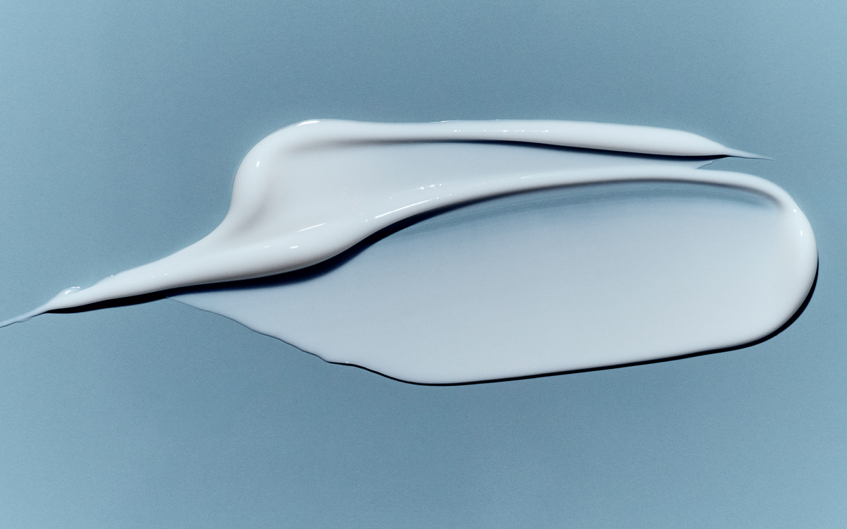 Swatch of rich white cream on a blue background